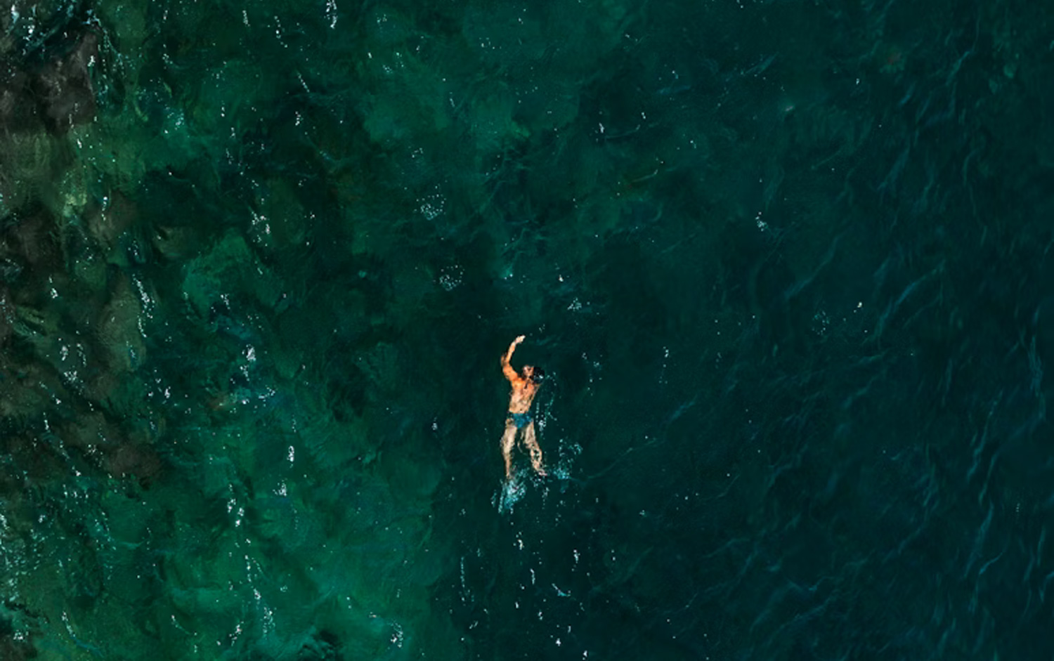 People swimming at Pattaya Beach Thailand clear sea conditions during dry season daytime