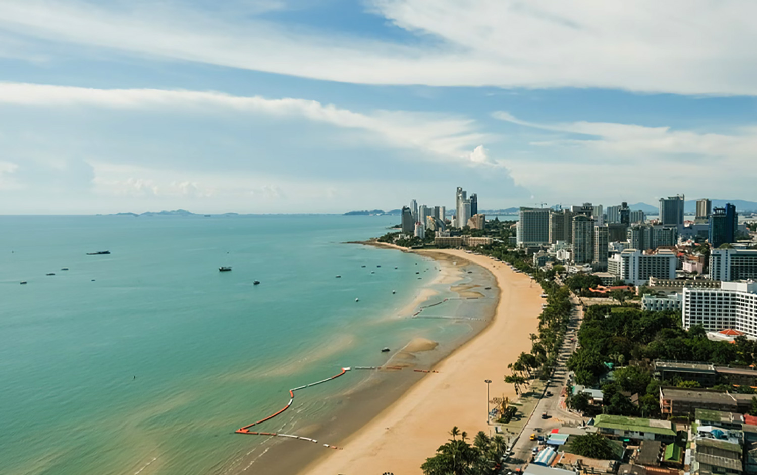 Pattaya Beach Thailand sandy shoreline and city skyline view in central Pattaya during daytime